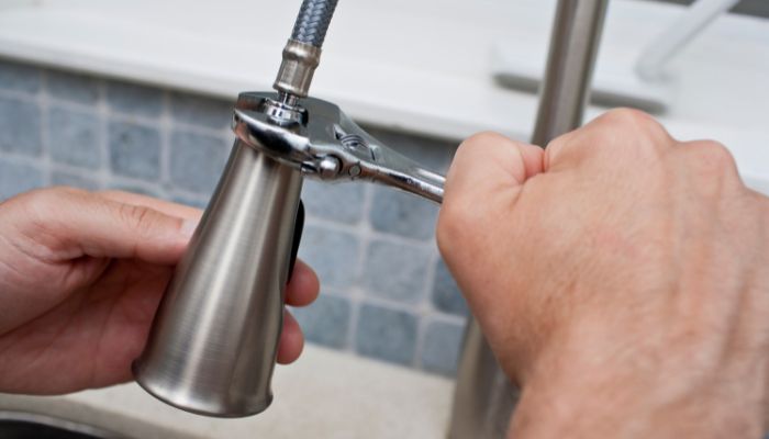 Removing a kitchen faucet using wrench